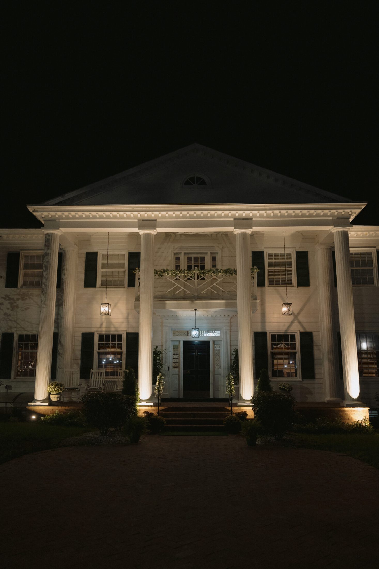 The Magnolia Mansion lit at night